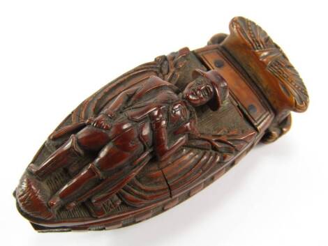 A Regency coquilla nut snuff box, carved with Napoleon being conveyed upon HMS Northumberland to captivity in St Helena.