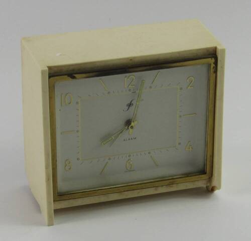 A German cream Bakelite savings alarm clock, white rectangular dial bearing Arabic numerals, with key, 12cm x 5cm x 10.5cm.