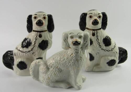 A pair of reproduction Staffordshire flat back spaniel dogs, and another, 29cm and 15cm.