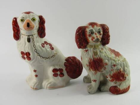 Two reproduction Staffordshire spaniel figures, with liver markings and gilt chains, 30cm and 28cm.