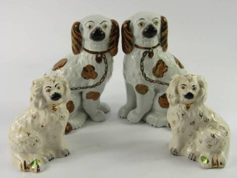 A pair of early 20thC Staffordshire pottery spaniels, with gilt markings and chains, together with a smaller pair of Beswick spaniels. (4)