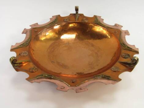 A modernist copper two tone bowl, decorated to the rim with geometric motifs and stands, stamped SF 1978, 43cm diameter.