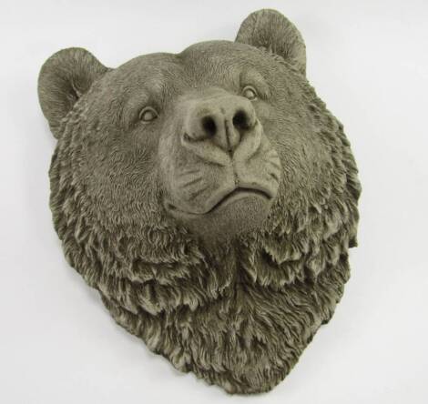 A concrete sculpture of a bear's head, 37cm x 31cm.