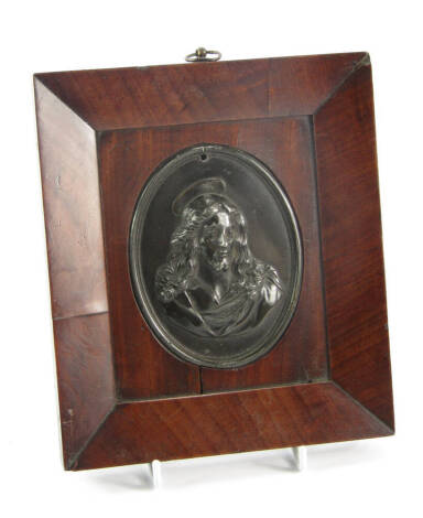 An oval bronze plaque of either Jesus Christ, or a saint, bust portrait in a mahogany frame, 20cm x 17.5cm.