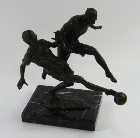 A bronze sculpture of two footballers, in action raised on a black marble base, bears signature Milo, 17cm x 13cm x 26.5cm.