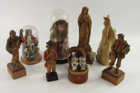 Two miniature doll dioramas, incorporated into glass domes, together with various carved softwood figures.