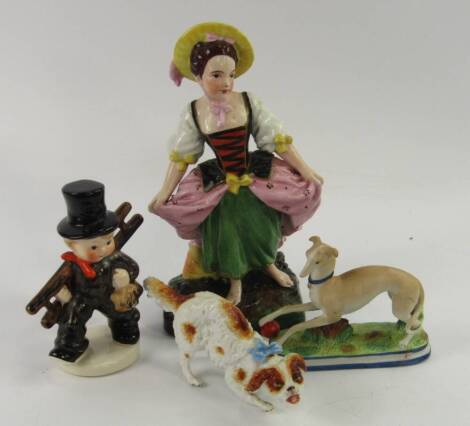 A Hummel figure of a boy with ladder, two 19thC ceramic figures of dogs and a Continental pottery figure of a girl, 24cm high. (4)