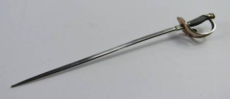 A white and yellow metal paper knife, modelled as a cavalry sword, 15cm long.