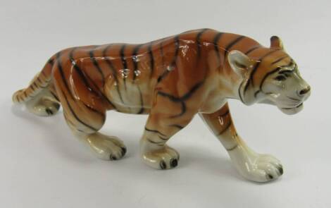 A Royal Dux pottery figure of a tiger, No 312, printed mark, 35cm long.