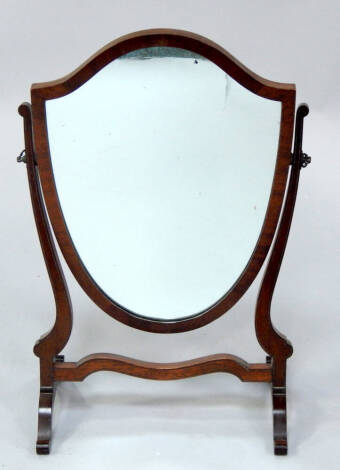 An Edwardian mahogany shield shaped swing frame toilet mirror, 57.5cm high.