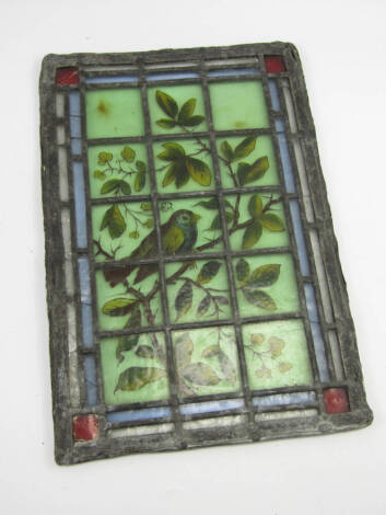 A Victorian leaded window light, hand painted with a bird on a branch, 35cm x 24cm.