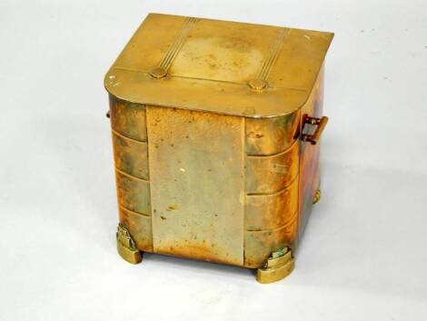 An Art Deco brass coal box, of twin handled lidded form, raised on stepped feet, 35cm x 29cm x 31cm.