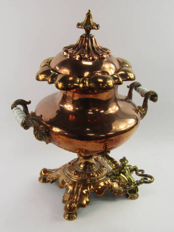 A late Regency copper tea urn and cover, of baluster form with turned opaque glass grips to the handles, brass tap, 49cm high.