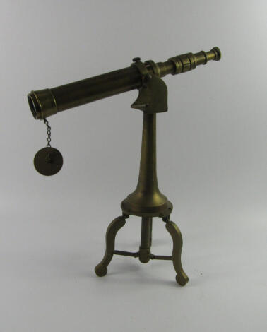 A brass telescope, on an integral tripod stand, 48cm high.