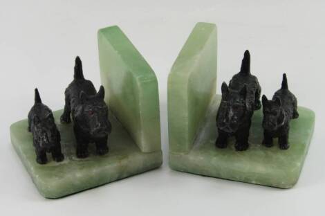 A pair of 1930s cast metal and green onyx bookends, modelled with pairs of terriers, 11cm long.