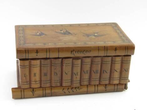 A Sorrento olive wood marquetry puzzle box, in the form of bound books and decorated with three swallows, 23cm wide.