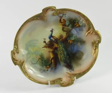 A Hadleys Worcester porcelain dish, circa 1907, painted by W Powell, signed, with peacocks perched in a tree, No 233.450.54, printed marks, 27cm long.