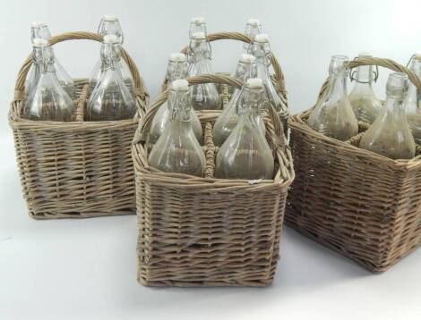 Four willow wicker four bottle baskets.