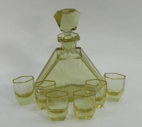 A Bohemian yellow glass liqueur set, circa 1930s of rhomboid faceted form, comprising decanter and stopper and six glasses.