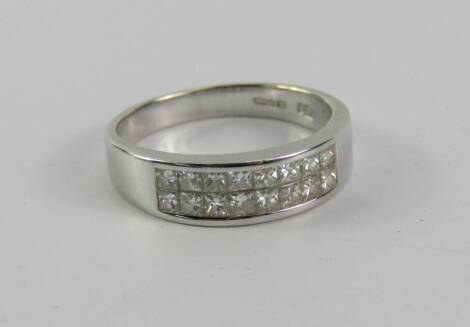 An 18ct white gold and sixteen stone diamond ring, square cut in a channel setting, approx 0.5cts, size N, 4.3g.