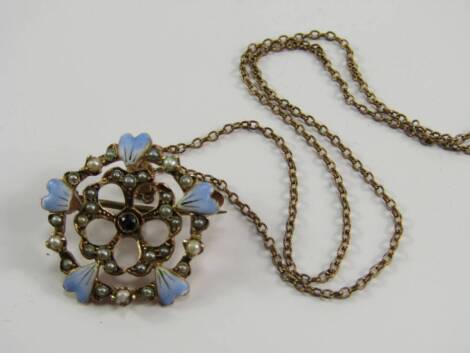 A pendant and chain, the pendant with enamel painted leaves, inset seed pearls and blue stone centre, on yellow metal frame, unmarked, together with a gold plated chain.