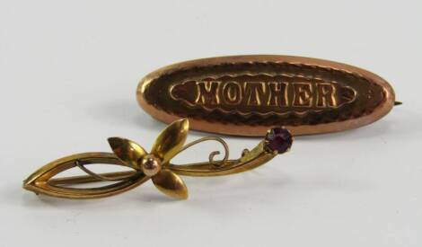 Two brooches, including a Mother brooch, in Victorian style, marked to back A.J.C., yellow metal marked 9ct, together with another brooch of a flower inset with a purple stone.