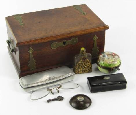 A Victorian brass bound oak box, containing a serpentine pocket compass, circular porcelain box printed with a hunting scene, scent bottle, pair of pince-nez and a horn snuff box.