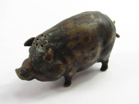 A brass pepperette, modelled as a pig, 8.5cm long.