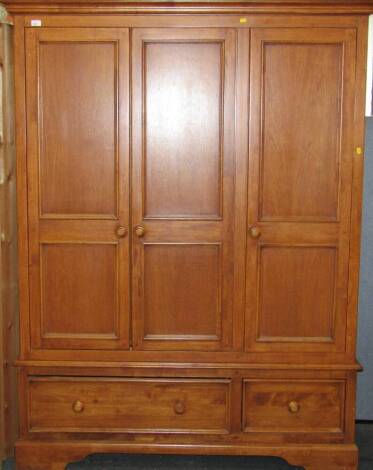 A Willis & Gambier three door wardrobe, with two drawers to base.