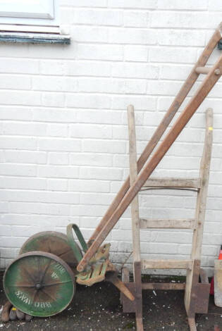 A vintage push rotovator, and vintage sack wheels, (2).