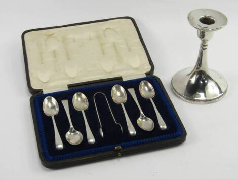 A George V loaded silver candlestick, Birmingham 1919, 12cm high, 6.4t oz, together with a set of six coffee spoons and sugar tongs, Sheffield 1937, 2.675t oz, cased.