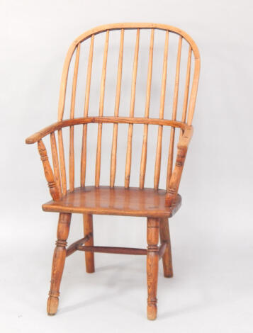 An oak and elm Windsor chair, late 18thC, with a square fronted, peg jointed seat, raised on turned front legs, united by an H frame stretcher.