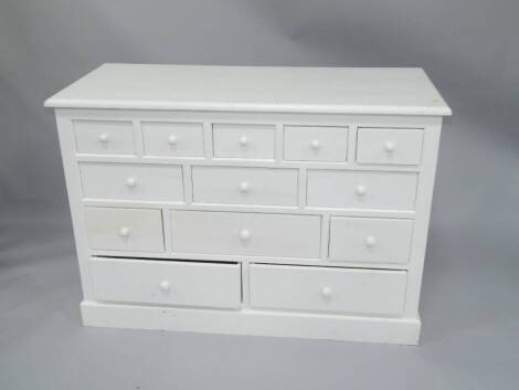 A white painted multi-drawer chest, 126cm wide