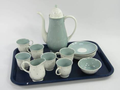 A Susie Cooper porcelain part coffee service, decorated in a blue polka dot pattern, comprising coffee pot, cream jug, sugar bowl, six cups and saucers, (AF).