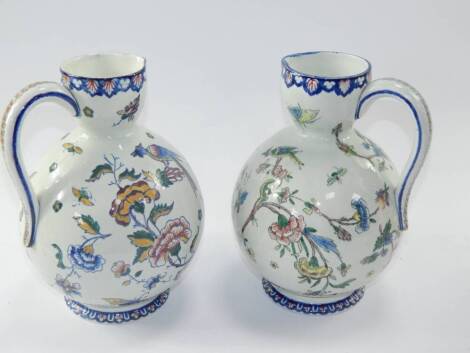 A pair of Gien pottery jugs, of baluster form decorated with cornucopia of flowers, birds and insects, printed marks, 22cm high.