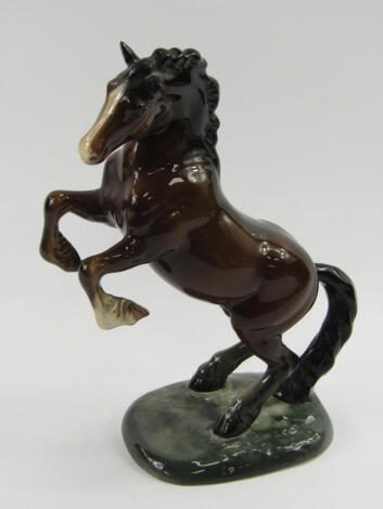 A Beswick figure of a prancing brown gloss horse, raised on an oval base, No 1014, impressed marks.