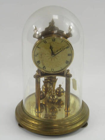 A Kundo brass tortion 400 day clock, dial bearing Roman numerals, under a glass dome, 24cm high.