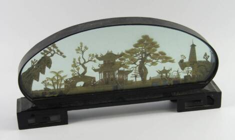 A Chinese cork carving of Pagodas, cranes and bridges in a landscape, hardwood cased, 16cm x 36cm.