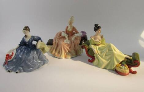 Three Royal Doulton figures, comprising Reverie HN2306, Elyse HN2429 and At Ease HN2473.