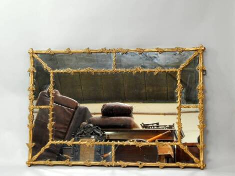 A gilt framed rectangular wall mirror in a pseudo-Chippendale style 158cm x 106cm