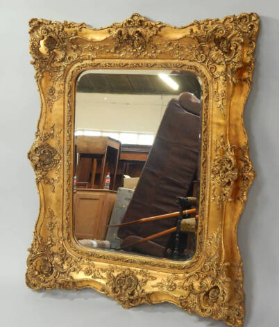 A modern gilt framed rectangular wall mirror of rococo design, with bevel plate, 125cm x 102cm