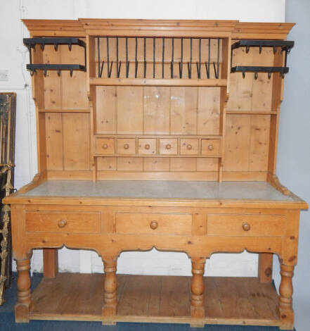 A marble top pine dresser, with a combination of wrought ironwork, plate rack and saucepan hangers, spice drawers, deep drawers and pot board 192cm wide, 63cm deep, 204cm high