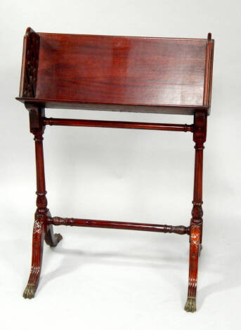 A reproduction Chippendale mahogany bookstand, with fretwork sides and carved framing, 63cm wide