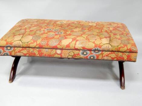 A Victorian style low stool, with mahogany stained x-frame base and floral tapestry seat, 122cm x 70cm