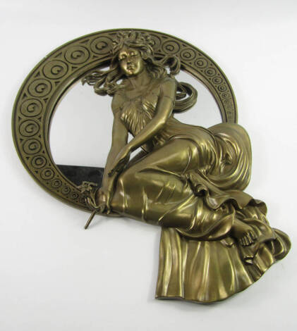 An Art Nouveau style gilt plaster wall mirror, moulded with a seated girl holding a posy of flowers within a crescent surround, 53cm high.