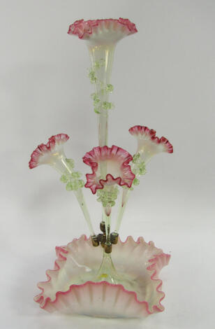 A Victorian opaline and green glass epergne, with four trumpets each with cranberry tinged frilled rims raised above a crimped square base, 50.5cm high.