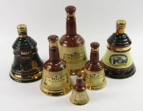 A graduated set of full Wade Bell's whisky decanters, together with two Christmas bells 1990 and 1995, (6).