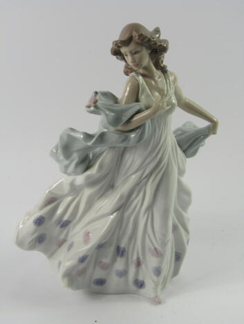 A Lladro porcelain figure of a lady, with a bird perched on her shawl, 32cm high.