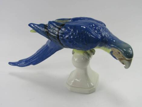 A Royal Dux porcelain model of a parakeet, blue feathers, raised on a stand, printed and triangle marks, 43cm long.