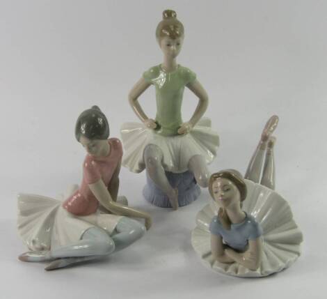 Three Lladro porcelain figures of ballet dancers, each modelled in a different pose.